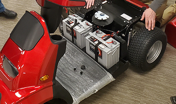 Technician servicing a mobility scooter